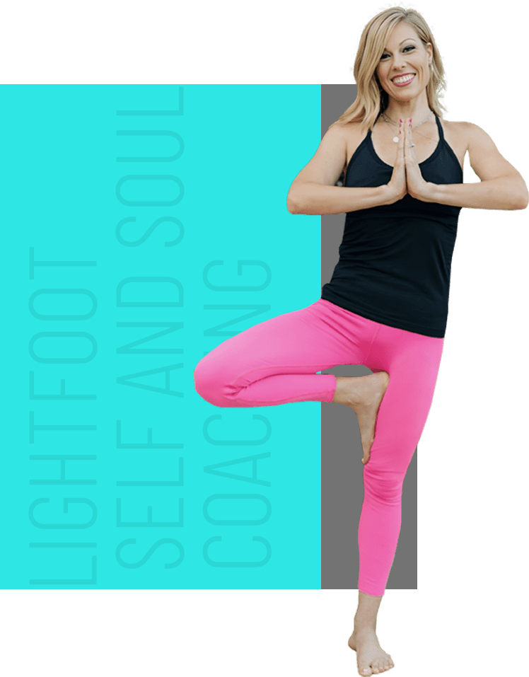 A woman in pink pants and black top doing yoga.